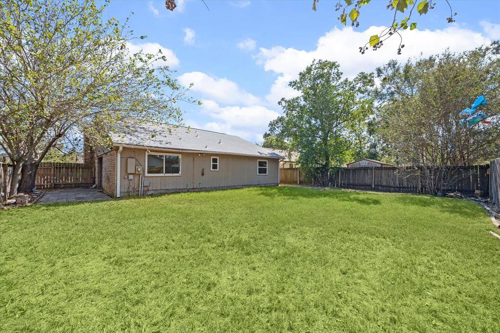 Expansive fenced backyard, offering ample space for outdoor gatherings, gardening, and play.