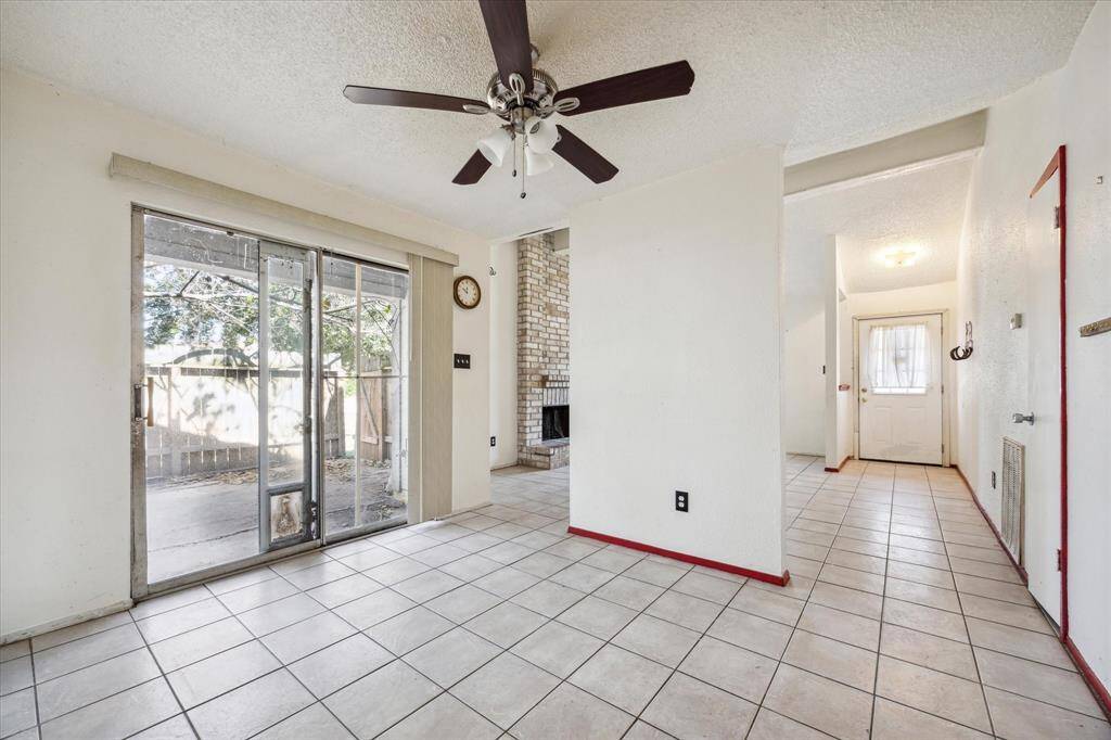 Welcoming front door opens to a bright living room, with a convenient back door leading to outdoor space, and a stylish dining/kitchen area perfect for entertaining.