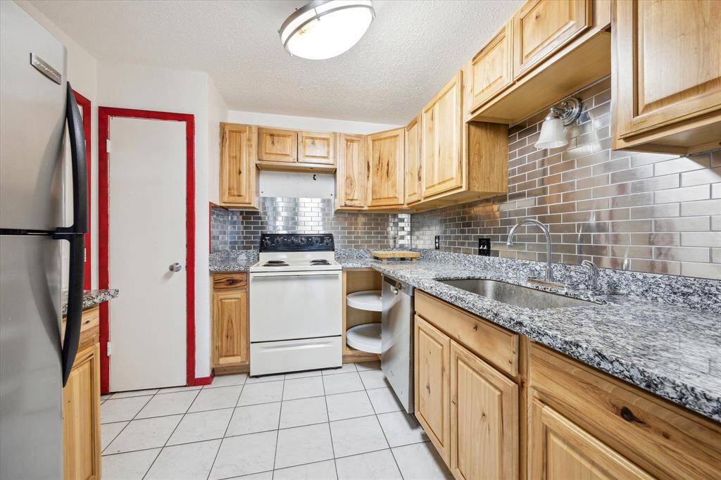 Functional kitchen featuring wall and base cabinets that offer plenty of storage for all your cooking essentials.