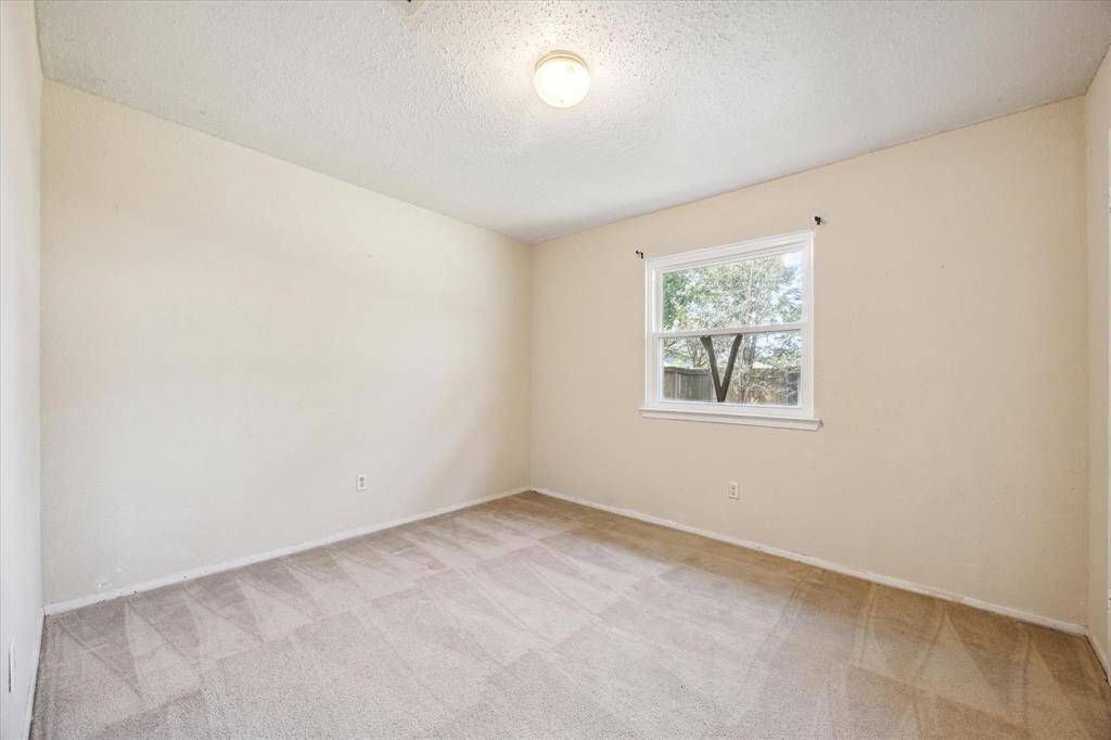 Cozy bedroom adorned with plush carpet and abundant natural light, creating a warm and inviting atmosphere.