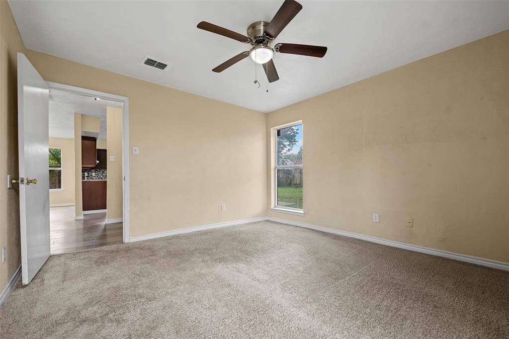 A large picture window with lush carpet and neutral paint ready to make it your own.