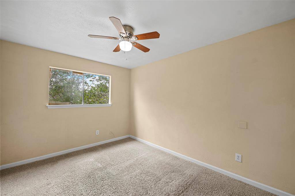 A secondary bedroom light and bright with views of the trees!