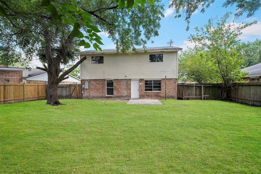 View of the back of the house with an area for a table and chairs to enjoy the outdoor space.