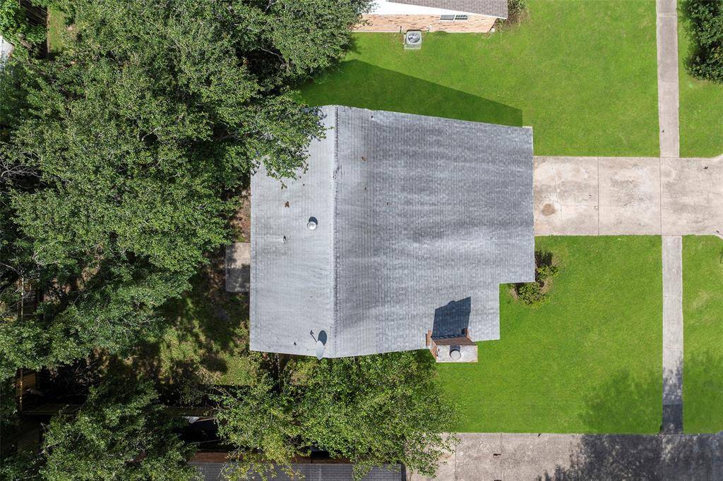 Aerial view of the property with lush trees.