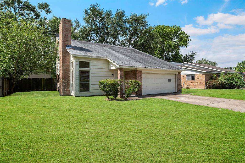 A charming 2 story with a large lush green front yard.