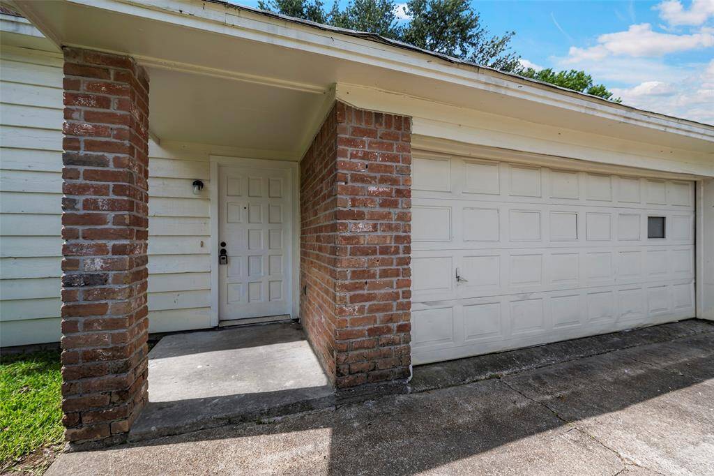 A brick column and accent wall lead to the front door welcoming you home.