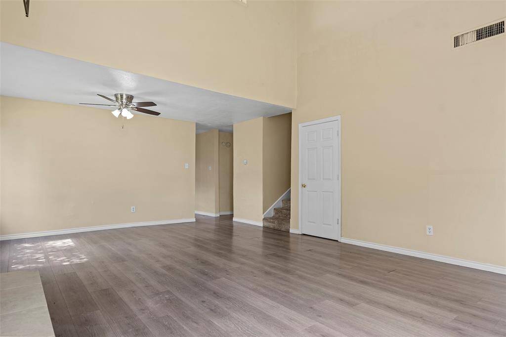 Another view of the living/dining area and stairs to the second story.