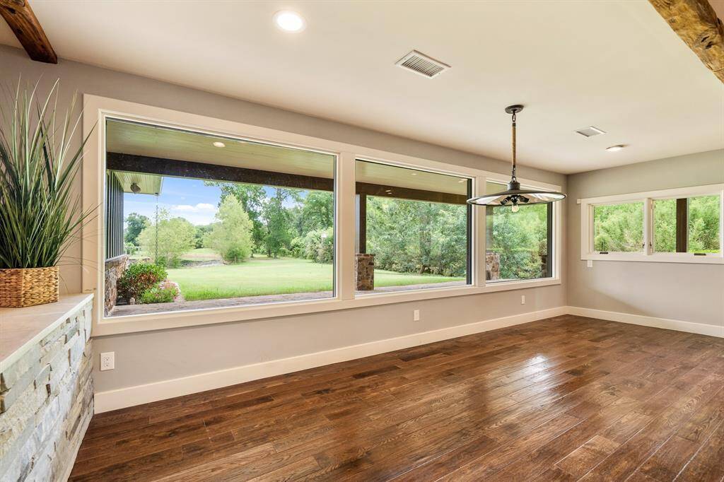 A beautiful stone wall artistically provides delineated space for this stunning Dining Room that measures 10x23 and is large enough for all the ranch hands. It is sure to whet the appetite and complement even the finest chef’s creations with gorgeous wood floors, a custom chandelier and panorama mouth-watering vista views.