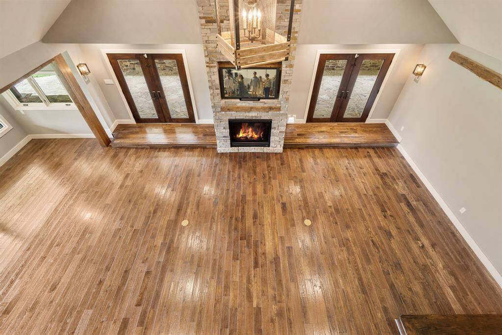 The Family Room is worthy of another look. This view provides a was taken from the upstairs landing providing a different perspective. Notice the thoughtful in-floor electrical outlets and the wall sconces.