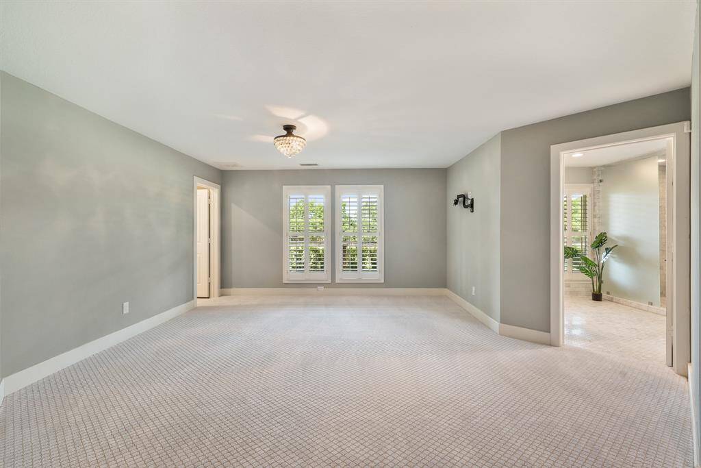 The spacious Primary Suite is sure to please. It is quietly tucked off the Foyer and offers plush carpet for warmth and quiet, while the Sitting Area offers the idea Retreat with remarkable views witnessed thru Plantation Shutters.