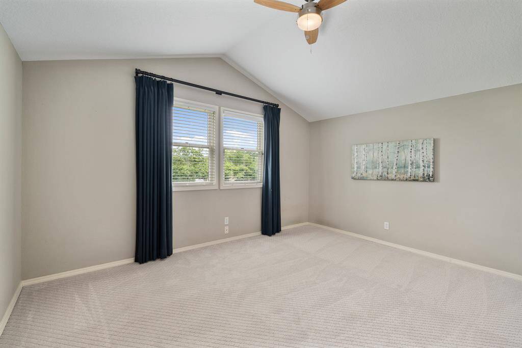 Upstairs are two large Bedrooms. This one has a vaulted ceiling, an upgraded ceiling fan, a large walk-in Closet and a pair of windows that overlook the front yard.