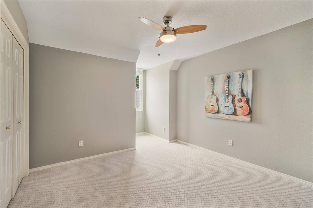 This is the other upstairs Bedroom that offers unique character with a Nook for the dormer window that overlooks the entrance to the home, a matching ceiling fan, large Closet and finished with NEW carpet that flows thru the entire upstairs.