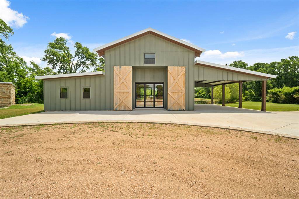 This is no ordinary Barn!  The design perfectly complements the home providing a stunning visual. Access is thru impressive 9-foot tall tri-fold glass doors and shielded by a pair of massive barn doors. On the left is a finished 8x15 Office or Workshop and a large secluded covered Porch with incredible pastoral views.