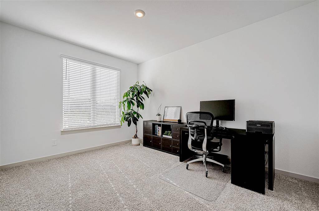 This versatile room, carpeted forcomfort, is a perfect option for ahome office or creative space.