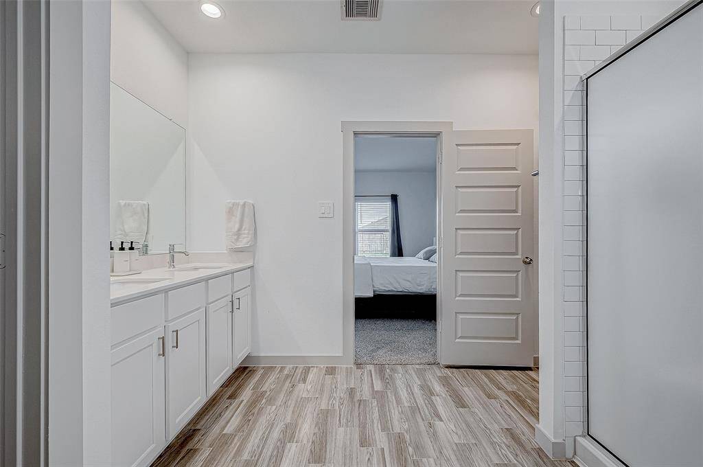 Thoughtfully designed, the en suitebathroom echoes the muted colorpalette of the rest of the home,creating a calming ambiance.