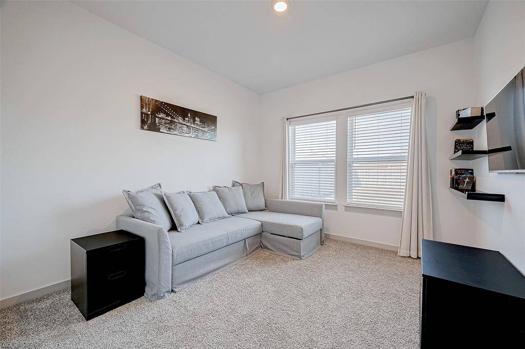 This adaptable carpeted secondary bedroomfeatures large windows that bring innatural light and recessed lighting fora bright, inviting atmosphere.