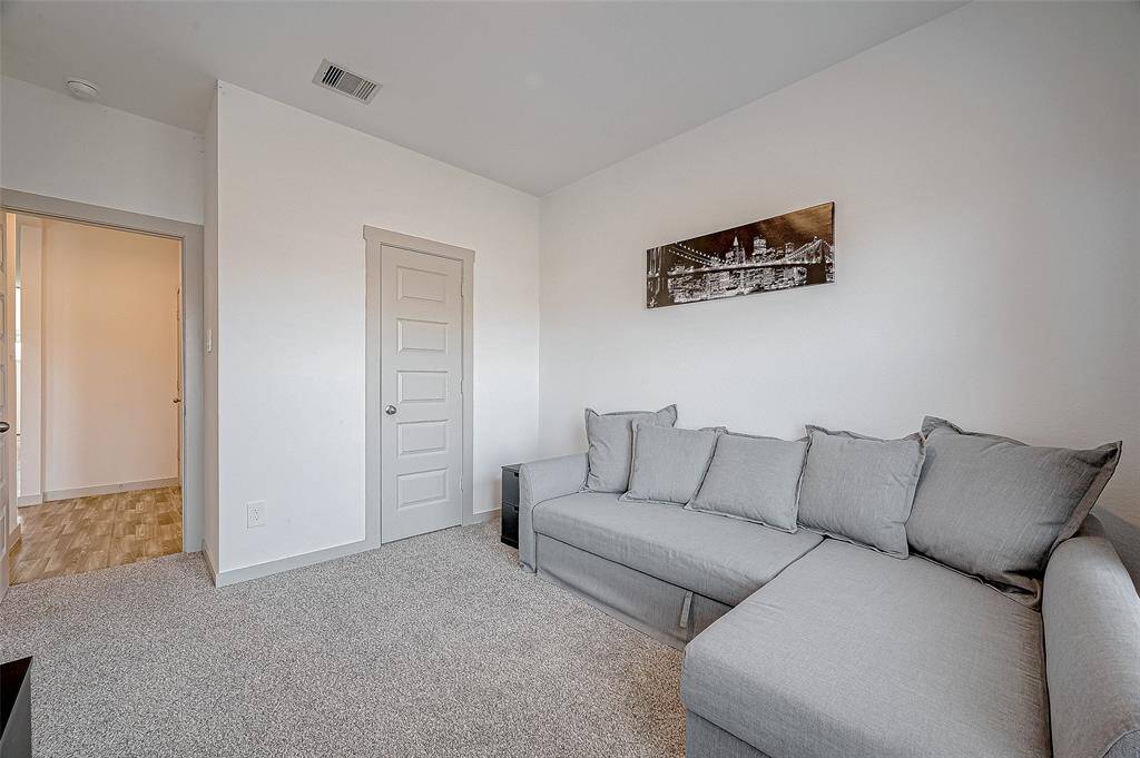 This versatile secondary bedroom is comfortableand inviting, perfect as a bedroom,den, or creative space.