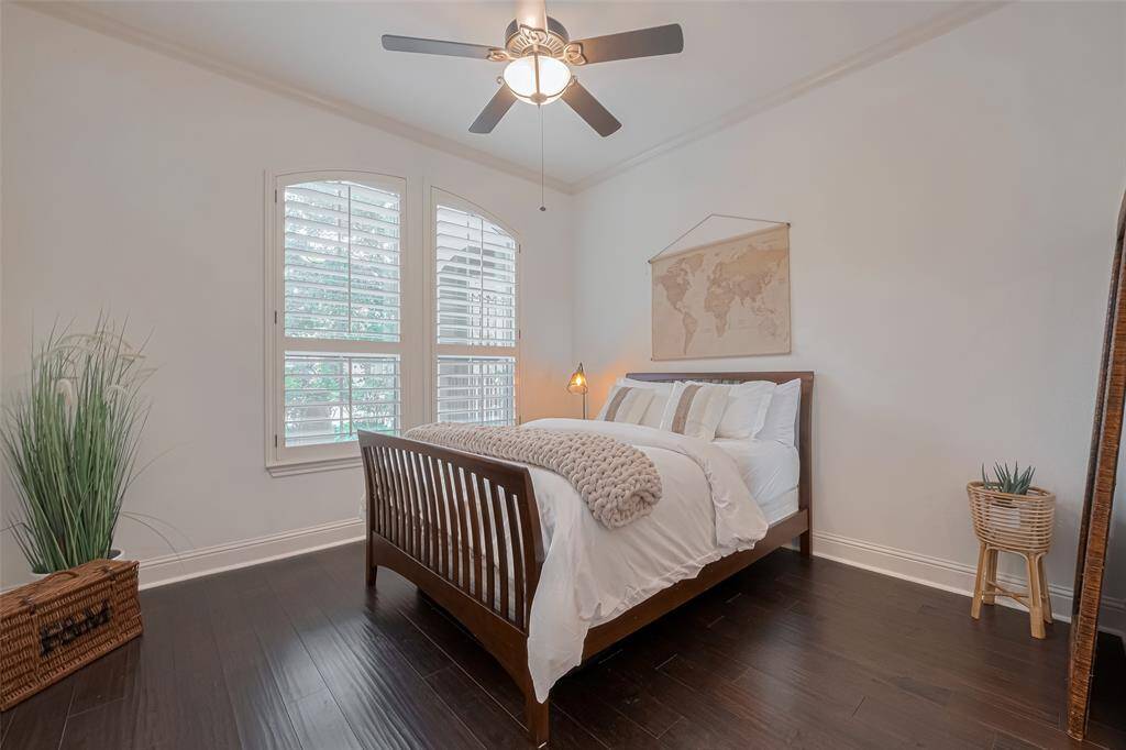 Secondary bedroom with large walk in closet and ensuite bathroom, ceiling fan, Plantation Shutters, eng. wood floors.