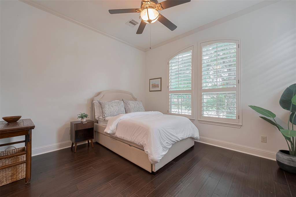 Secondary bedroom just off the front entry with walk in closet, eng. wood floors, ceiling fan and Plantation Shutters, this bedroom also has an ensuite bathroom.