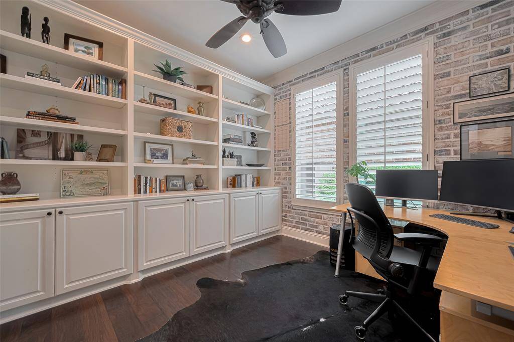 Built in bookcases and storage, Plantation Shutters, ceiling fan, French doors, faux brick wall prof painted with designer accent walls.