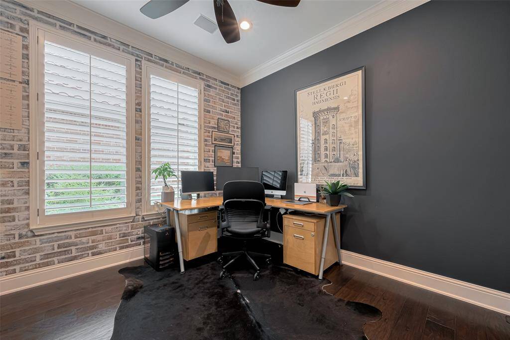 Large study with Plantation Shutters, designer ceiling fan, custom built in display book case with cabinet storage below, eng. wood floors, recessed LED lighting on dimmers, study with French doors for privacy.
