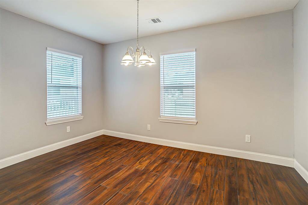 This is a bright, dinning room and a traditional chandelier.
