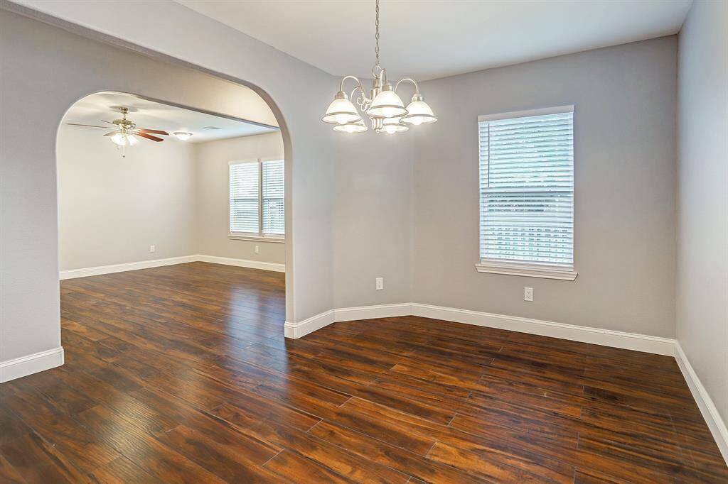 This is a spacious, well-lit room dinning room with a view of the living room.