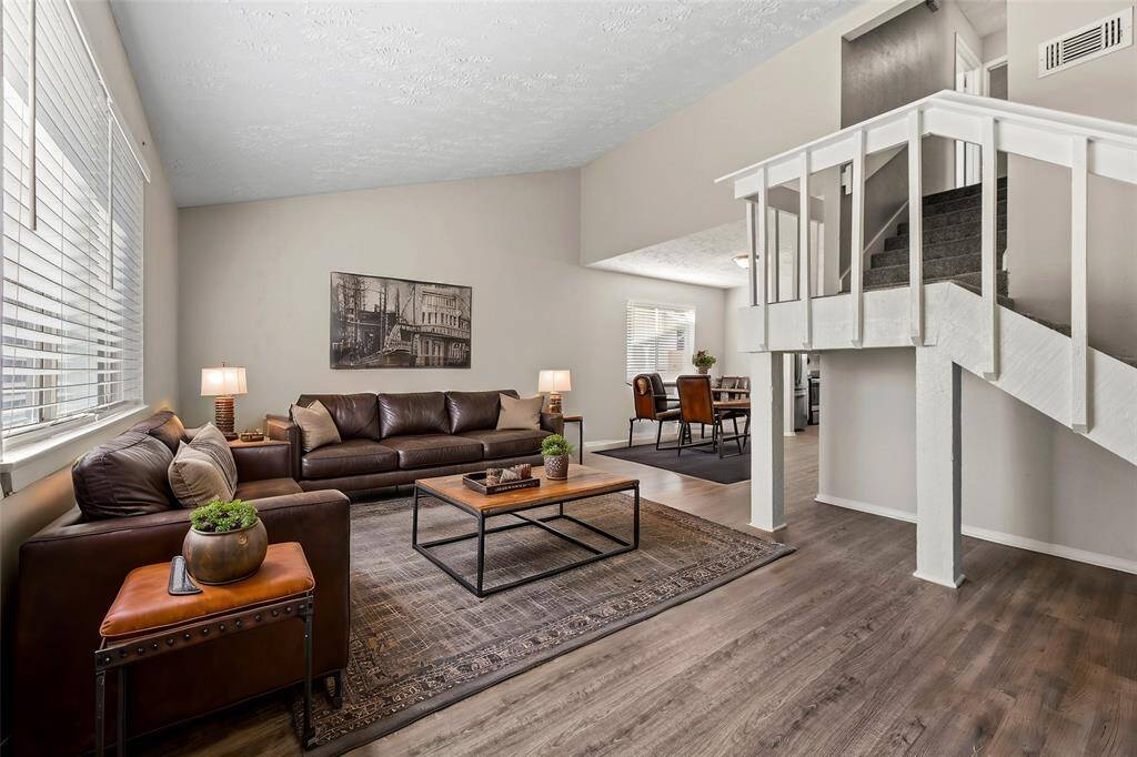 To the left of the entry is your formal living area. The large bright windows and easy-care vinyl wood flooring bring a timeless elegance to the space, providing a rich foundation that adds warmth and character.