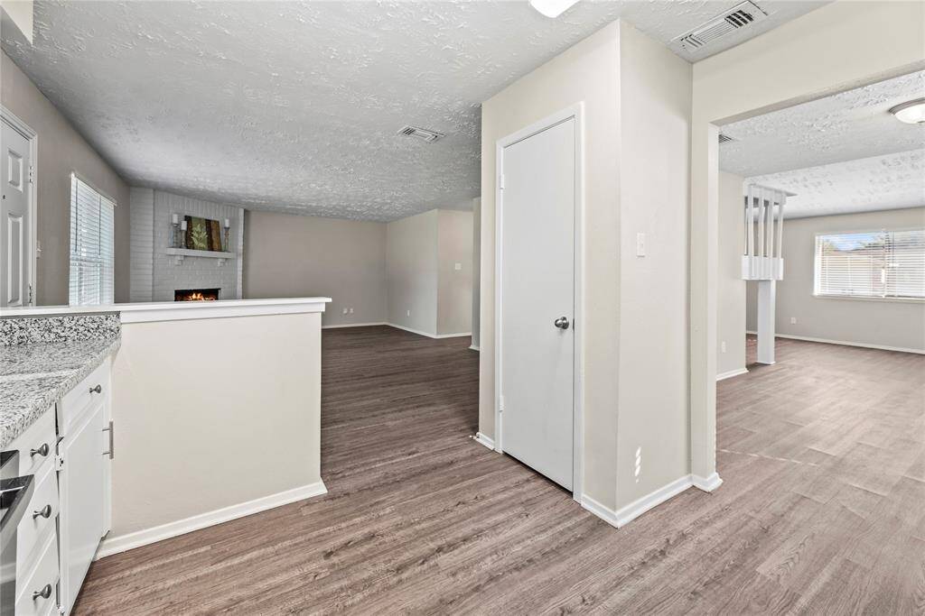 The family room, adjacent to the kitchen and dining area, offers a comfortable and inviting space for relaxation and socializing.