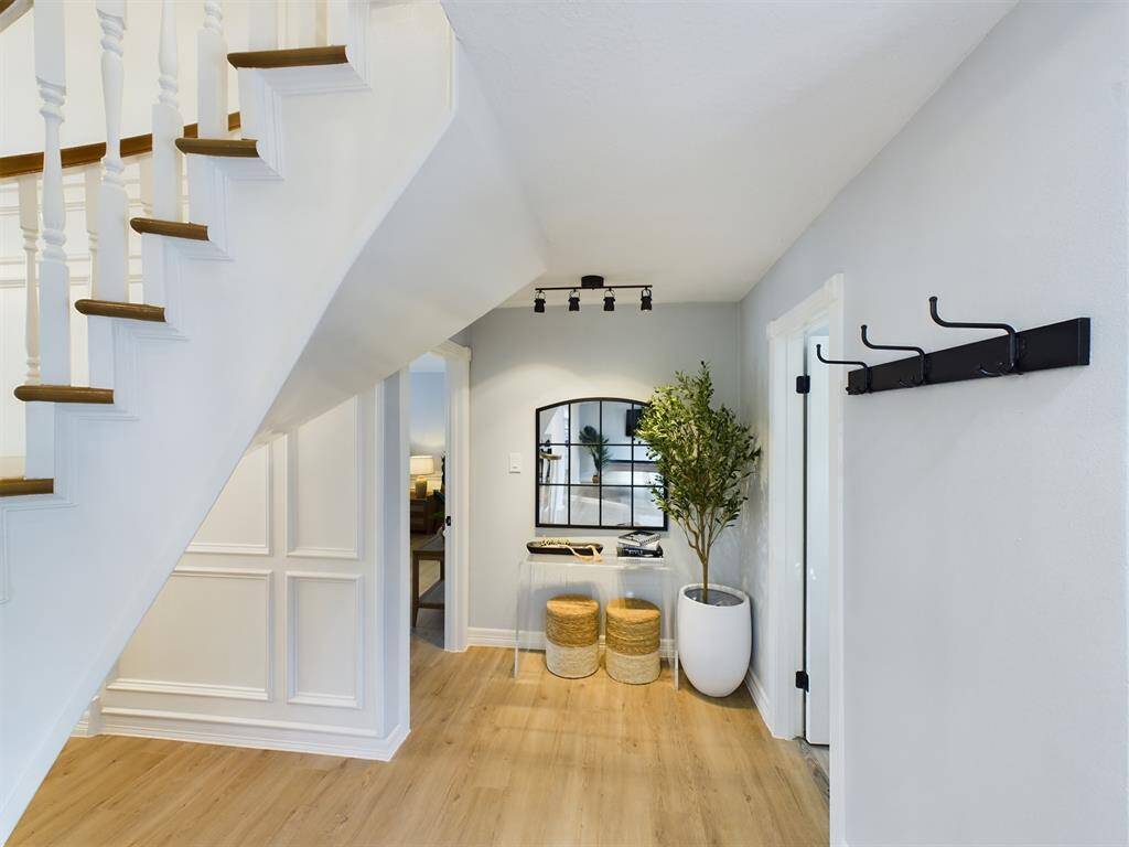 Back Across the Foyer to the Powder Room & Primary Bedroom