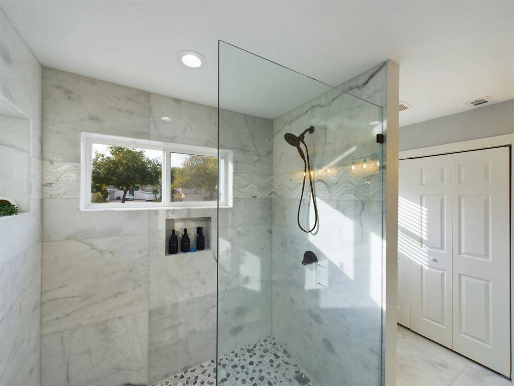Wonderful Oversize Shower with Marble Tile Walls, Stone Flooring and Glass Wall