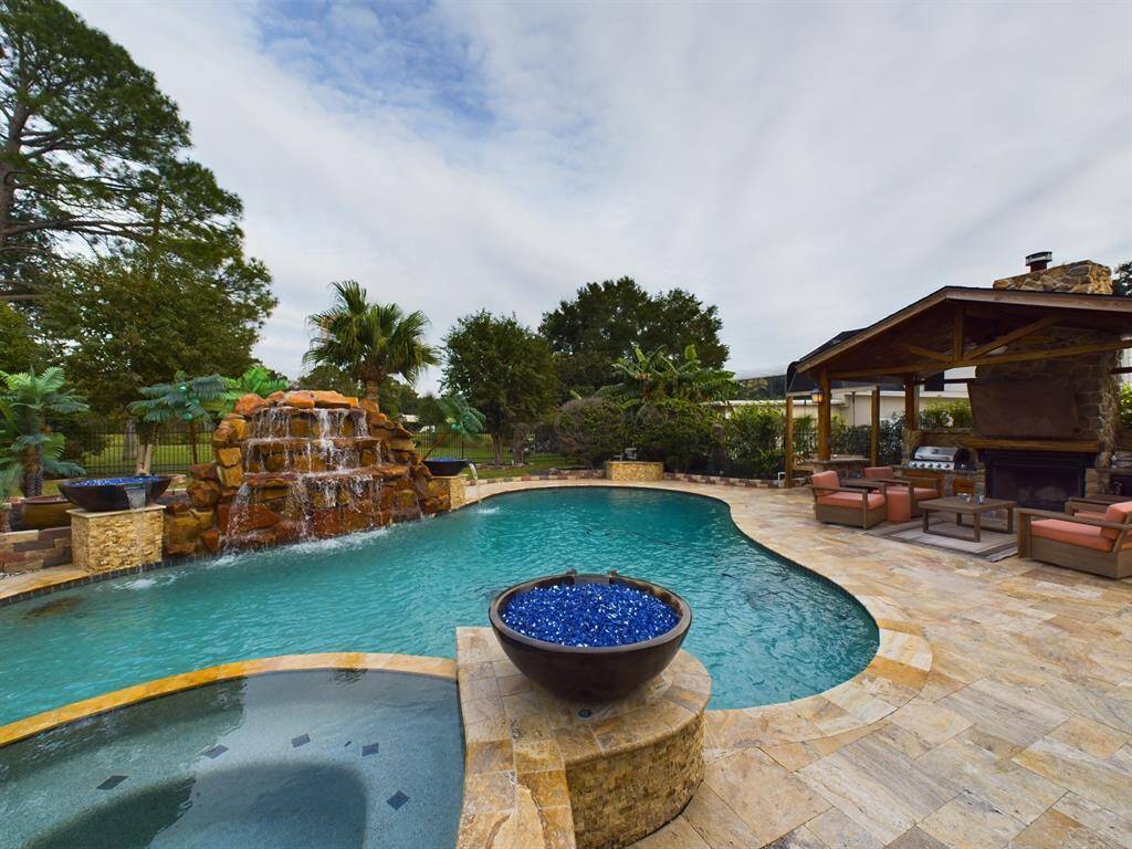 Spectacular Backyard with Heated Pool, Jacuzzi, 8' Waterfall, Water Features, Pavilion, Gazebo, Firepit, Patio Area AND Greenbelt in the Rear!!