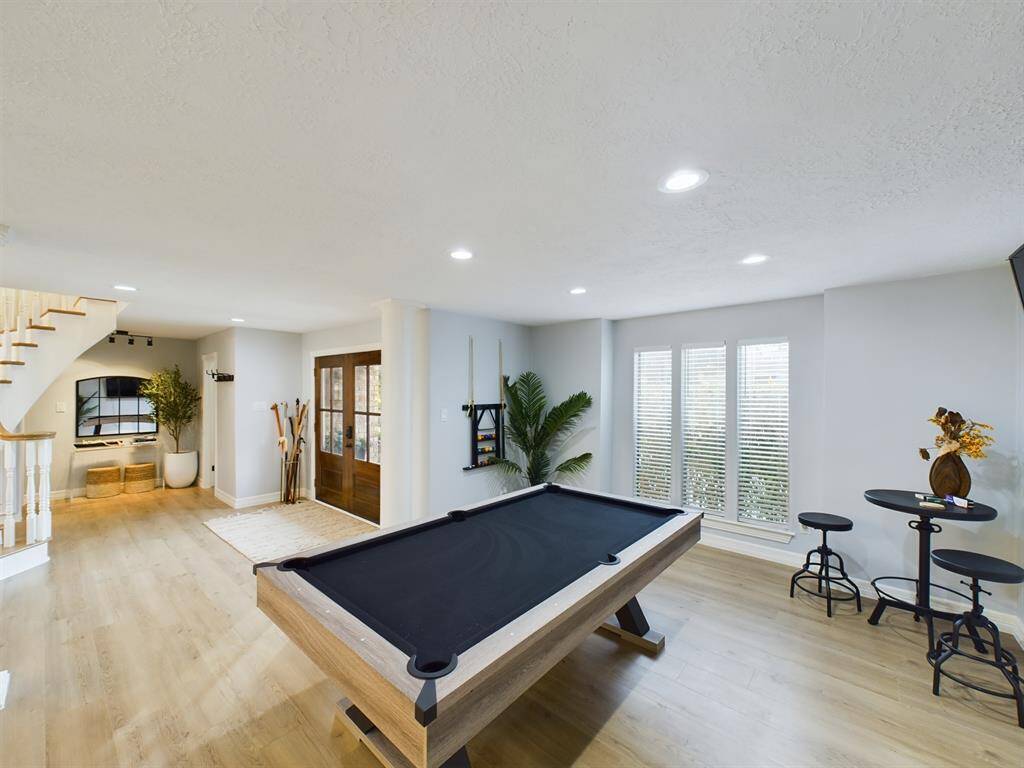 Billiards Room Off the Foyer with Powder Room and Primary Bedroom Across