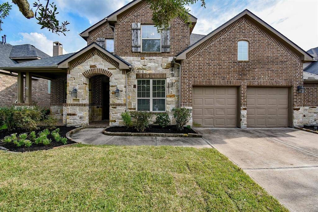 The rich, earthy tones of the brick complement the textured stonework, adding depth and character to the architecture. Arched entryways, detailed masonry, and charming accents enhance the curb appeal, while large windows framed in classic trim allow natural light to warm the interior. Perfectly balancing rustic charm with refined sophistication, this brick and stone masterpiece makes a striking first impression.