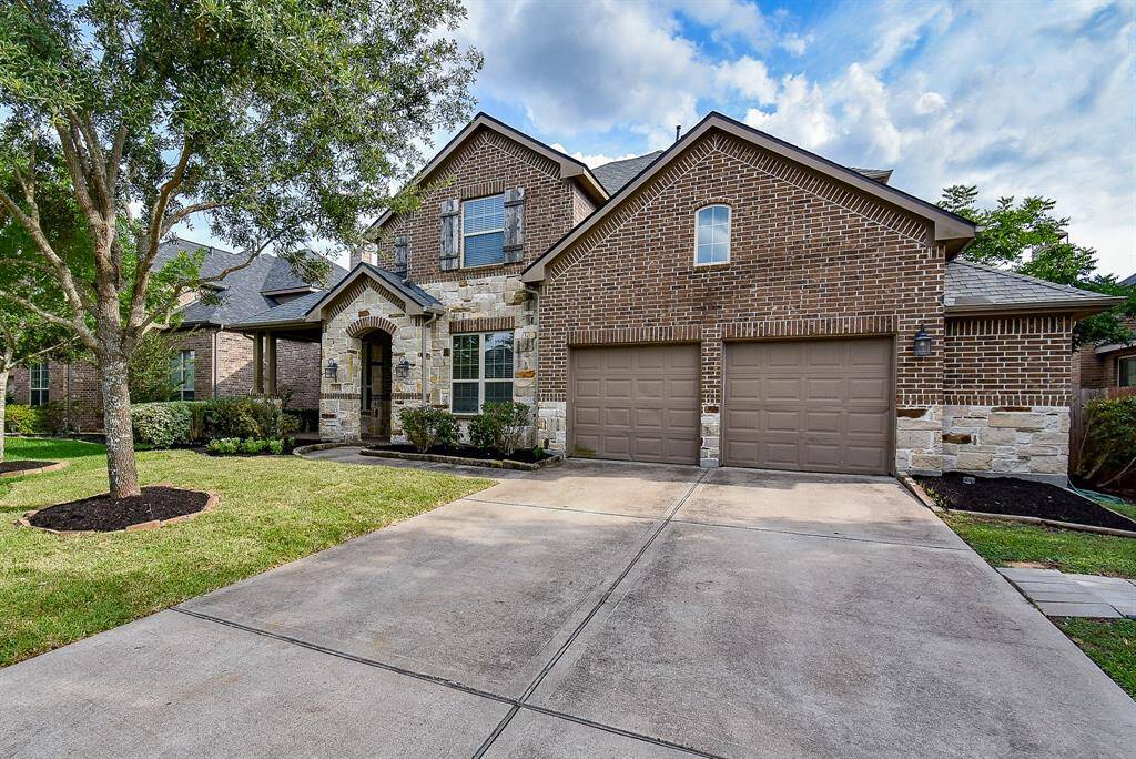 This home features a spacious, well-paved driveway that offers ample parking for multiple vehicles, perfect for entertaining guests or accommodating a busy household. The extended garage provides additional space beyond the standard layout—ideal for extra storage or a workshop.