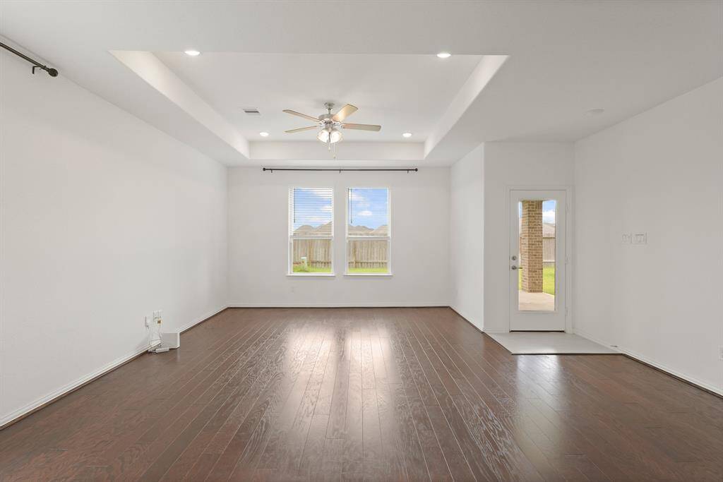 Modern Family Room with clean lines and neutral tones offers easy access to the patio, where natural light and fresh air enhance everyday living.