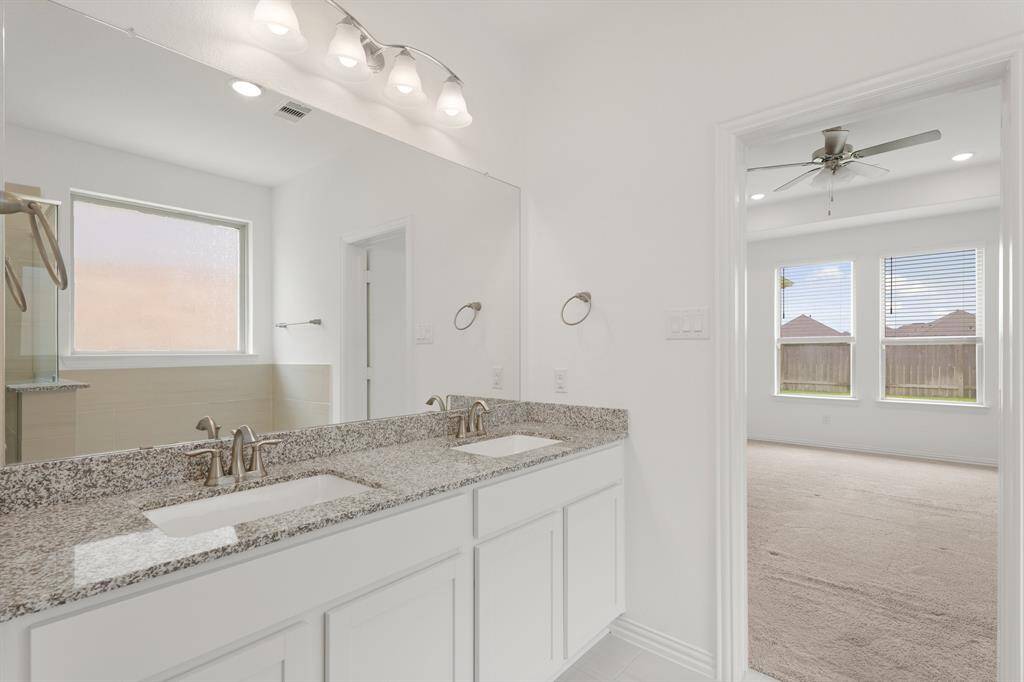 En Suite Primary Bathroom offers a double vanity, modern finishes and an abundance of counter & storage space.