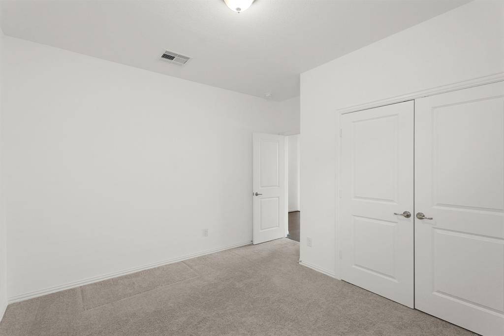 Bedroom #4 is set apart from the other secondary bedrooms, offering a quiet space with generous closet storage.