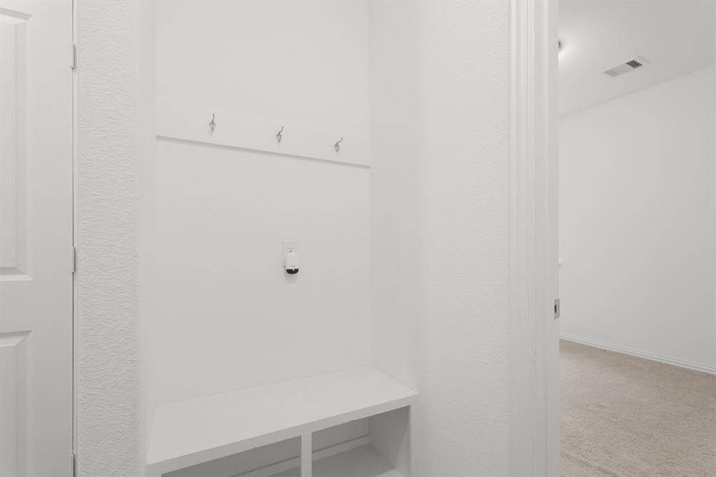 Functional Mudroom with bench seating, storage, and hooks for easy organization and a clutter-free entryway.