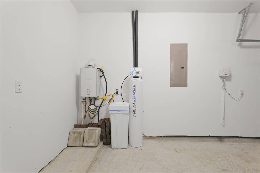 Spacious Garage offers ample room for vehicles and storage, with the added benefit of a whole-house water softener system to improve water quality throughout the home.