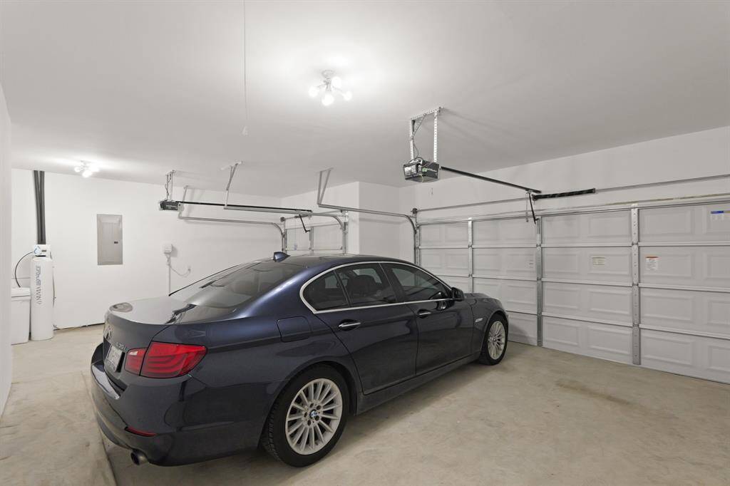The spacious 3-car garage features upgraded multi-bulb lighting that creates a bright and practical area.