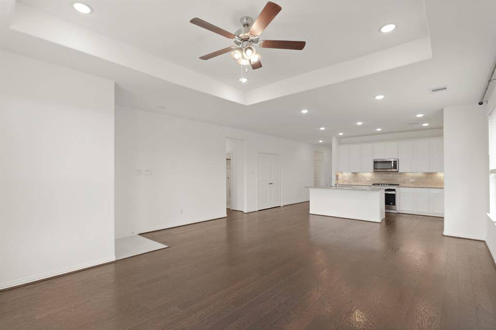 Open-concept Family Room boasts beautiful hardwood floors and a spacious flow that connects effortlessly to the Kitchen and dining area, creating the ideal environment for both relaxation and socializing.