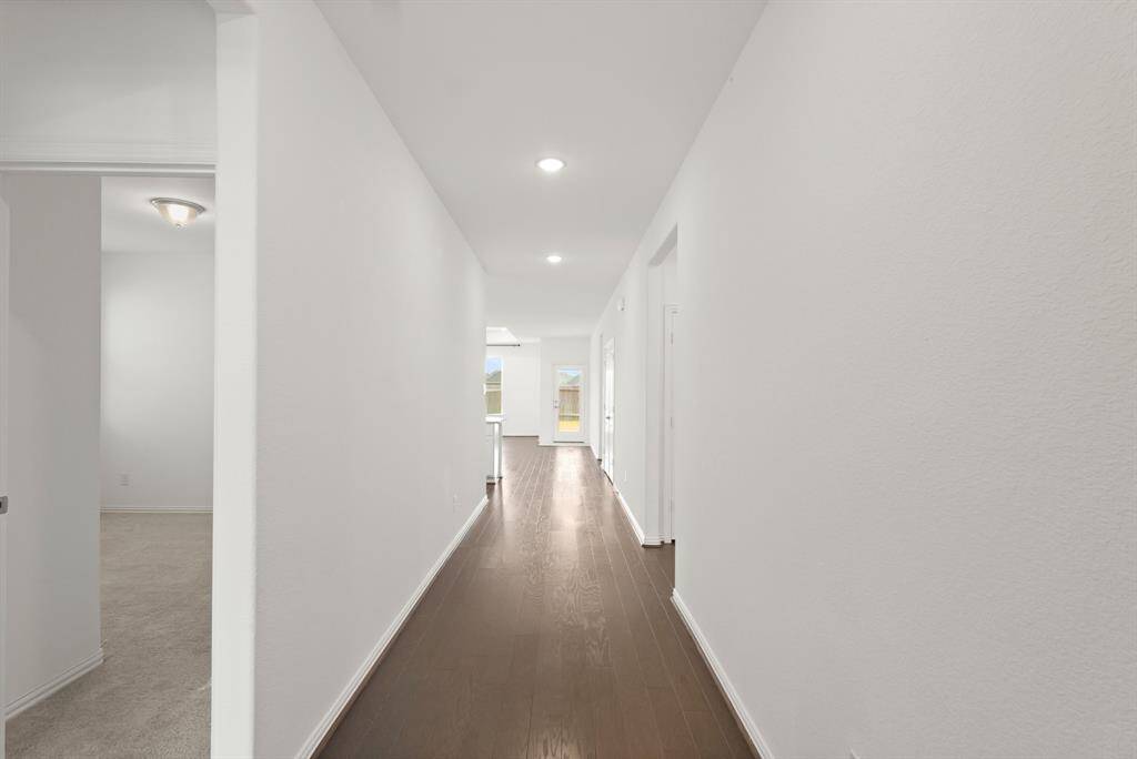 Step inside to a welcoming Entryway with a private secondary bedroom and full bath at the front of the home, perfect for guests or a quiet Home Office.