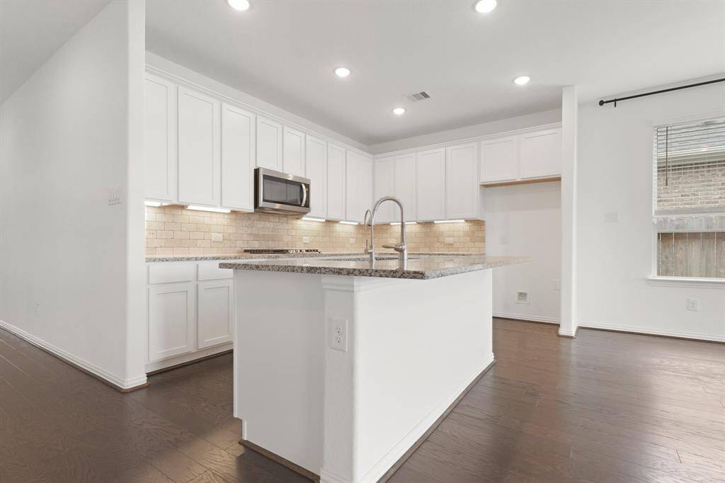 Equipped with stainless appliances, including a built-in microwave and gas cooktop, the Kitchen is ready for everyday cooking or gourmet meals
