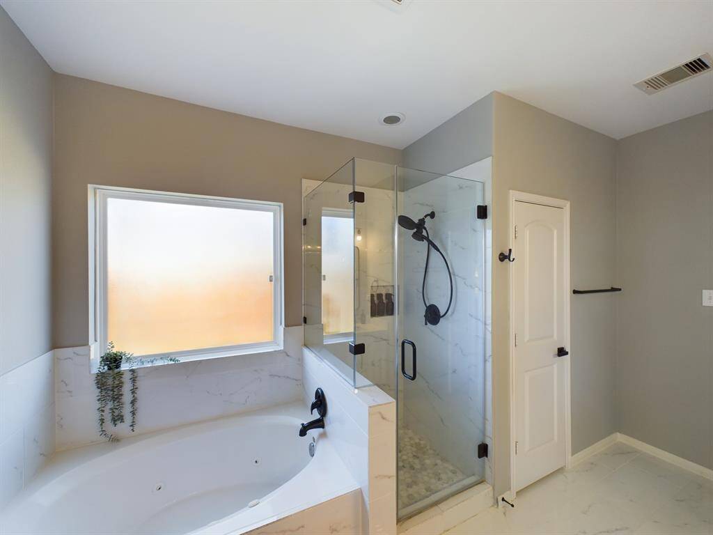 Large Jetted Soaking Tub and Separate Glass Enclosed Shower plus Water Closet