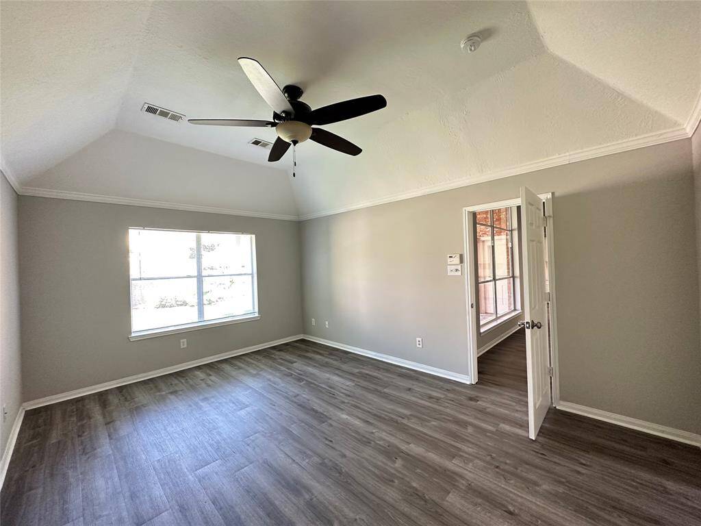 Primary bedroom is split from the other bedrooms.  The cove ceiling accentuates the roominess of this space.
