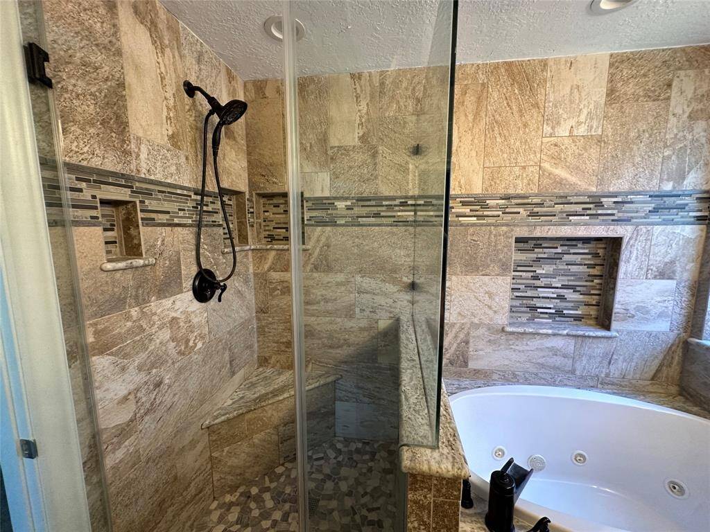 Separate shower has hand sprayer, seat and niches for shampoo.  By the way, the tub jets are not working but the tub is great for soaking your cares away.