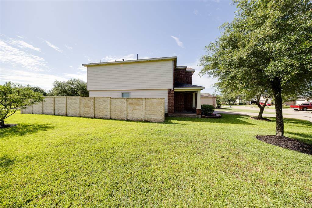 Spacious side yard opens to a lush greenbelt—ideal for privacy, outdoor fun, or extended gatherings.