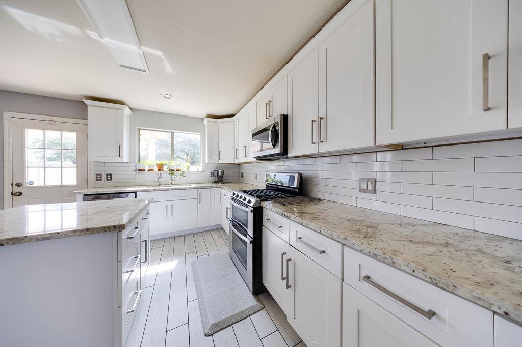 Gourmet kitchen featuring Quartz countertops, stainless steel appliances, and a central island for easy meal prep.