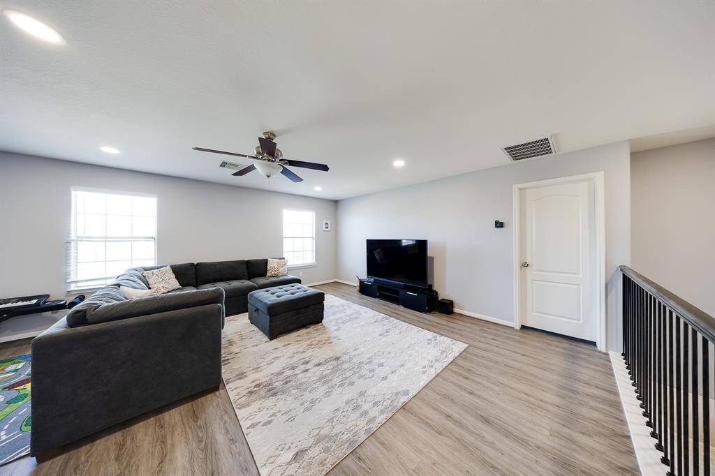 Multiple seating arrangement options in this oversized upstairs living area with warm floors.
